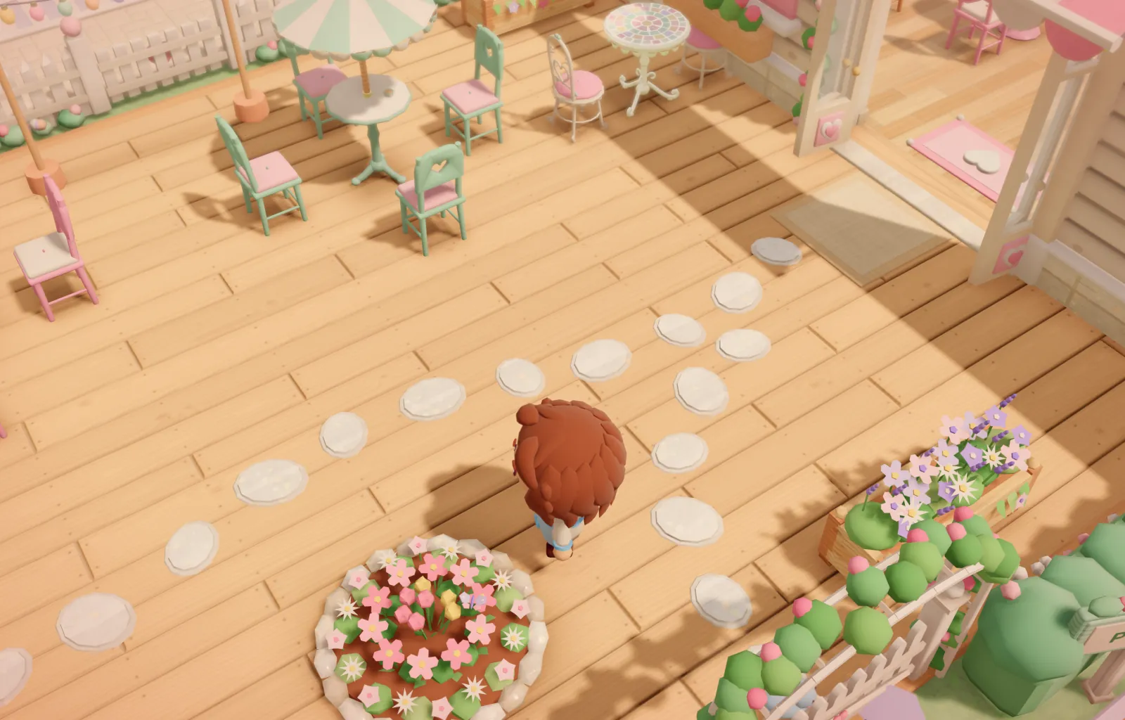 Capture du jeu : la terrasse en bois, ses chaises vert d’eau, un parasol rayé et un massif de fleurs.